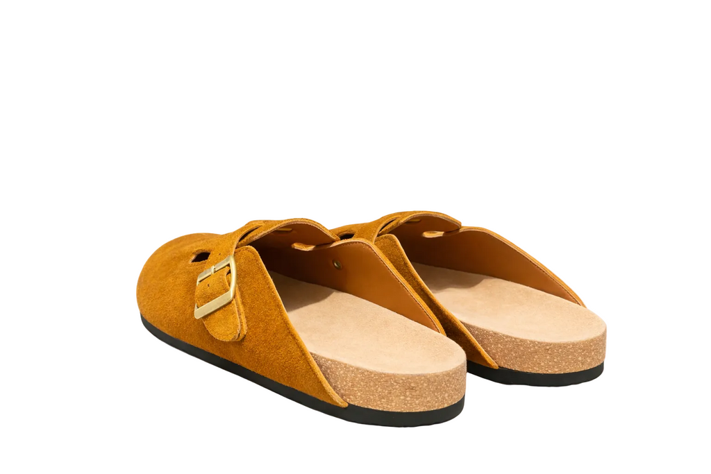 Pair of mustard yellow sandals with cork sole on a white background