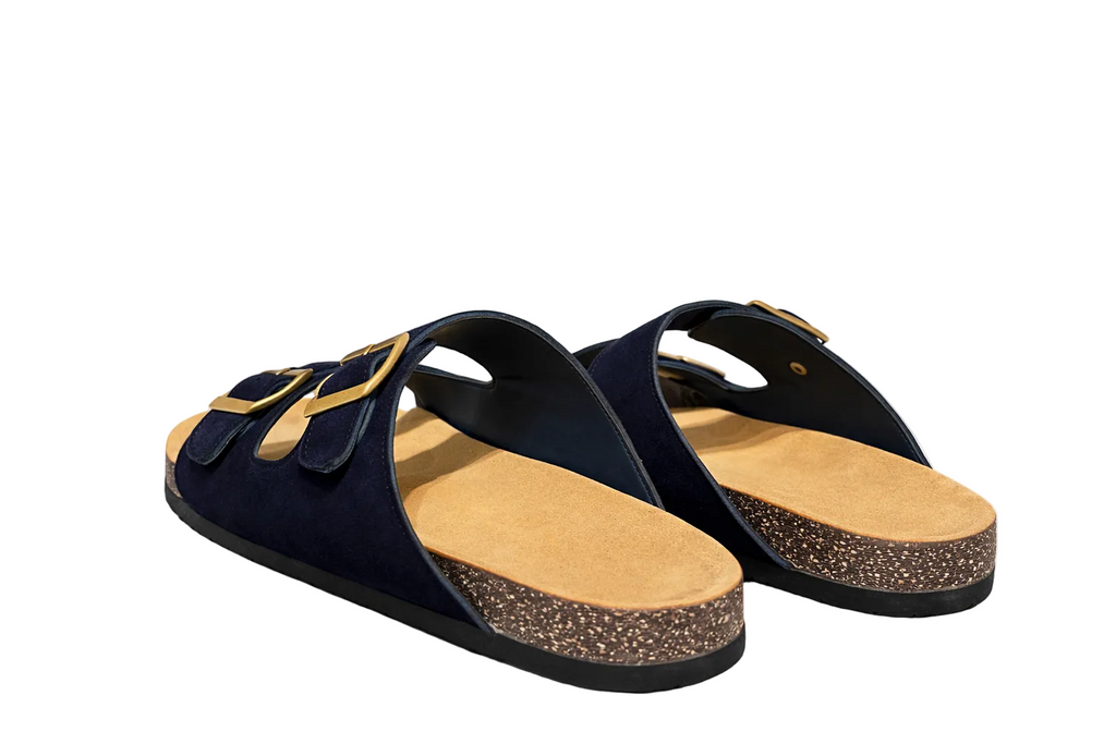 Pair of navy sandals with cork sole on a white background