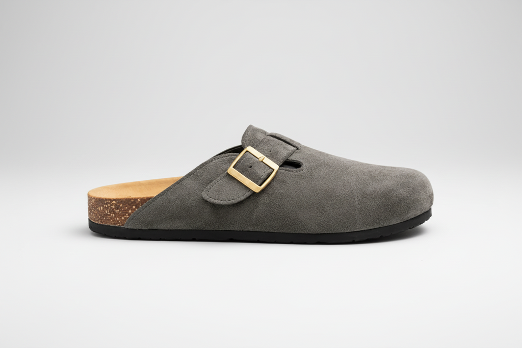 Gray suede clog with a gold buckle on a white background